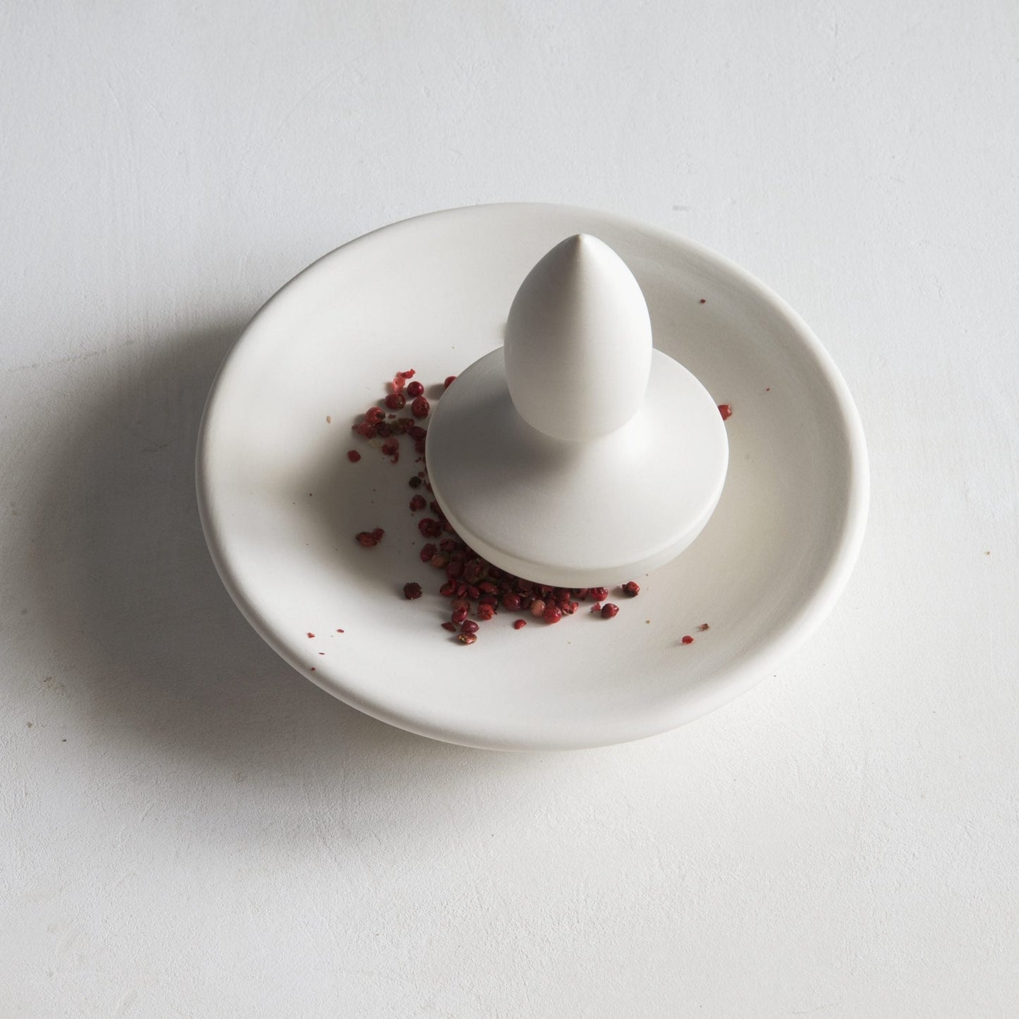 Flat mortar with small spear pestle, porcelain
