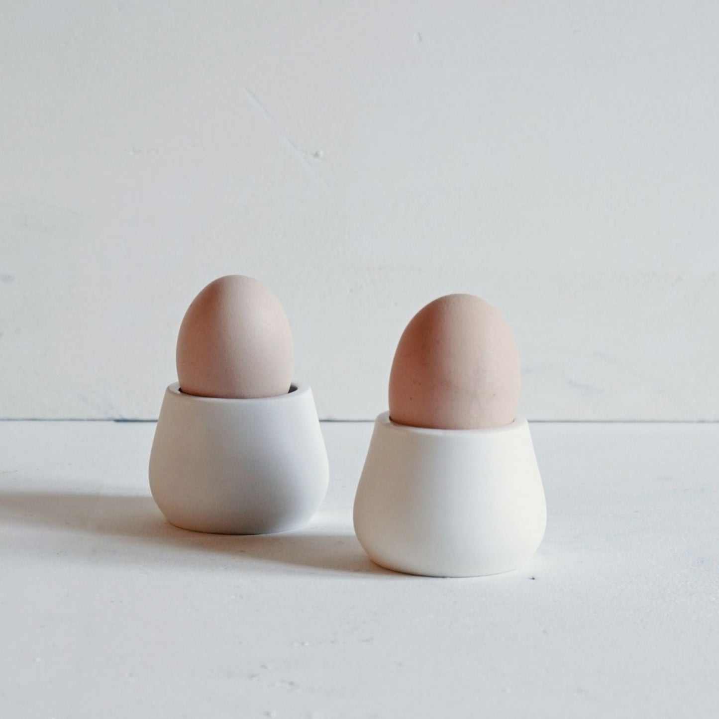 Simple hand thrown egg cups in porcelain