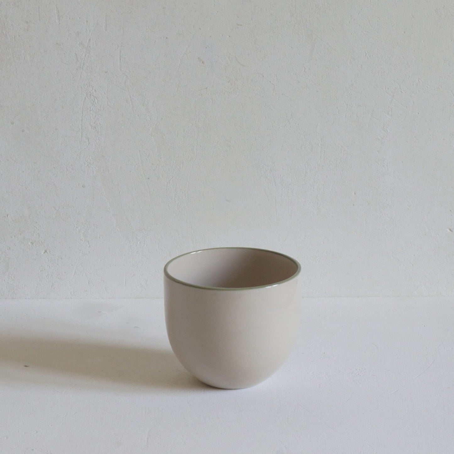 Simple stoneware beaker with green rim