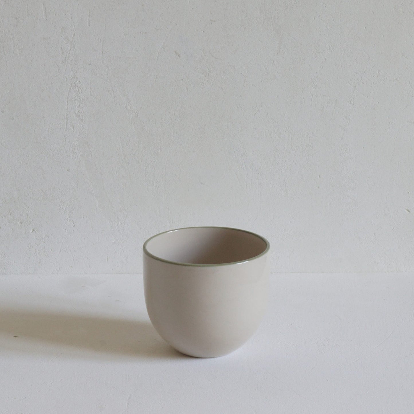 Simple stoneware beaker with green rim